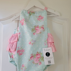Teal floral romper with bow