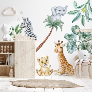 May include: A set of jungle animal wall decals featuring a zebra, lion, giraffe, elephant, and palm tree. The decals are painted in a watercolour style with a white background.