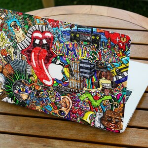 May include: A colourful laptop skin with a doodle-style design featuring a tongue, music notes, a building, and the word "MUSIC".