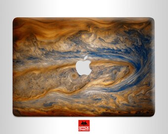 May include: A laptop skin with a swirling pattern of blue and brown, resembling the surface of Jupiter. The Apple logo is visible in the center of the skin.