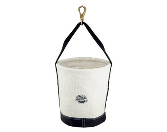 May include: A white canvas tool bucket with a black leather trim and a black strap with a brass hook. The bucket has a black logo that says "Graintex" and "Look for quality".