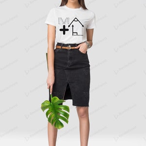 May include: A white t-shirt with a black graphic of a protractor, ruler, and plus sign. The graphic says "MA +" on the shirt. The model is wearing a black skirt and black sneakers.