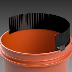 May include: A close-up of an orange plastic bucket with a black plastic insert. The insert has a series of vertical ridges and is partially inserted into the bucket.
