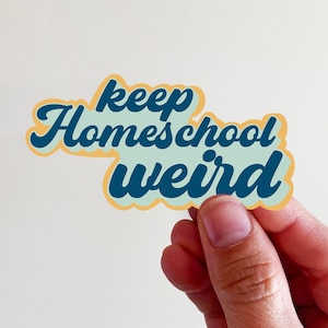 May include: A blue and yellow sticker with the text "keep homeschool weird" in a retro font.
