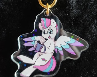 May include: A clear acrylic keychain featuring a cartoon pony with pink and blue hair, wings, and a tail. The pony is holding a purple mug and is surrounded by stars. The keychain is attached to a gold star-shaped clasp.