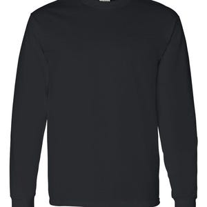 May include: A solid black long-sleeve t-shirt featuring a classic crew neckline and straight-cut sleeves with ribbed cuffs. The garment is constructed from a plain, opaque fabric and displays a simple, unadorned design throughout the front.