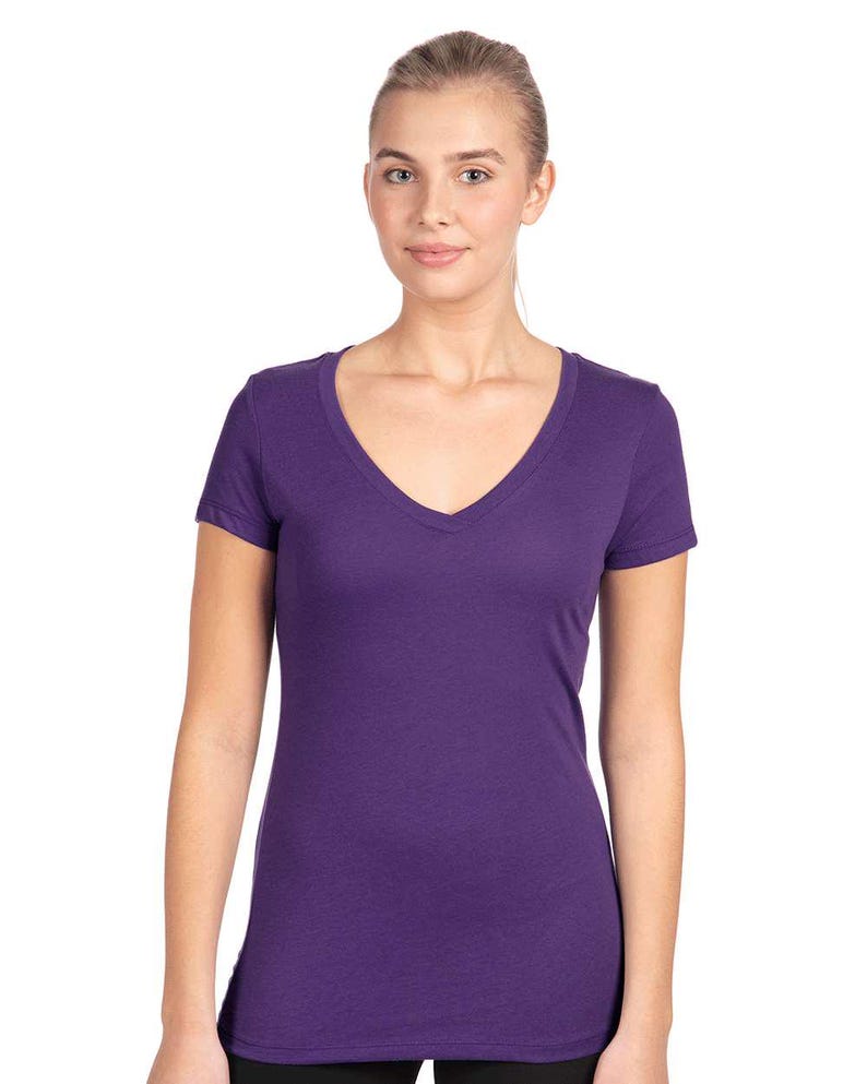 May include: A solid deep purple short-sleeved t-shirt featuring a V-neckline. The garment is constructed with a fitted silhouette, short sleeves, and a straight hemline, providing a clean and simple look in a vibrant, saturated purple color.
