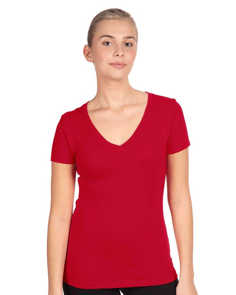 May include: A solid red short-sleeved t-shirt featuring a deep V-neckline. The garment is constructed from a smooth, opaque fabric and has a fitted silhouette that extends to the hip area, providing a clean and simple look for everyday wear.