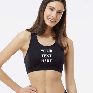 May include: Black sports bra with a white print that says "YOUR TEXT HERE".