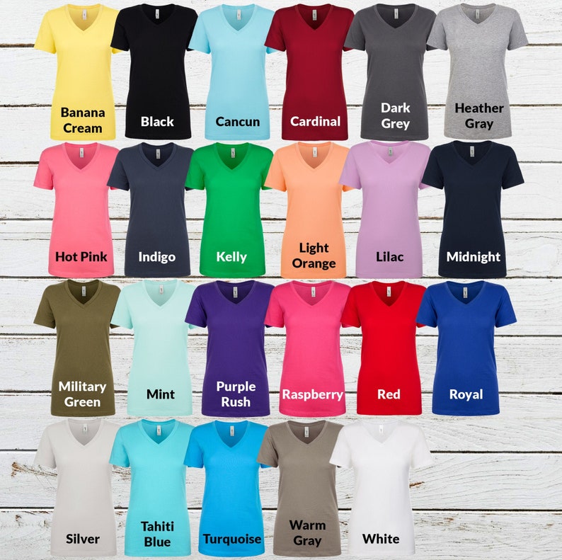 May include: A collection of twenty-three short-sleeve V-neck t-shirts in various solid colors including banana cream, black, cancun, cardinal, dark grey, heather gray, hot pink, indigo, kelly, light orange, lilac, midnight, military green, mint, purple rush, raspberry, red, royal, silver, tahiti blue, turquoise, warm gray, and white.