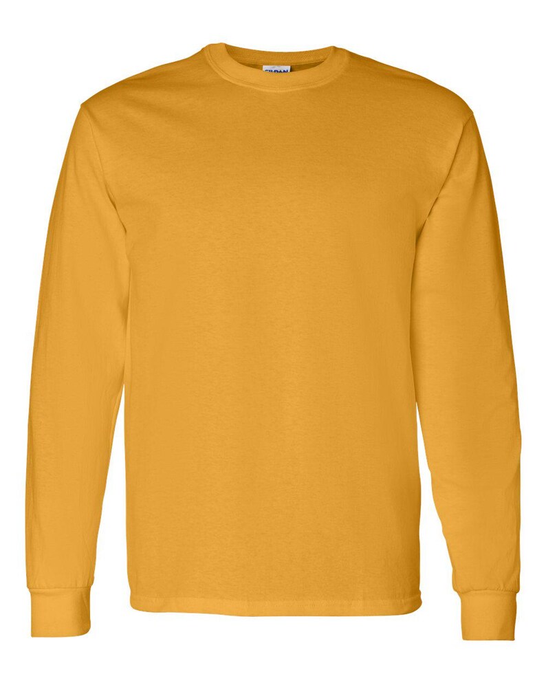 May include: A solid gold-colored long-sleeve t-shirt with a crew neckline and ribbed cuffs. The garment features a plain, unpatterned design with a standard fit, showcasing a consistent mustard yellow hue throughout the entire fabric surface.
