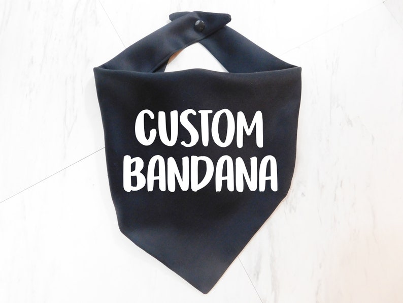 May include: Black bandana with the text "CUSTOM BANDANA" in white lettering.
