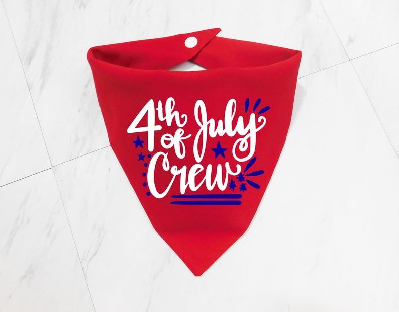 May include: Red bandana with a white design that says "4th of July Crew" with blue stars and fireworks.