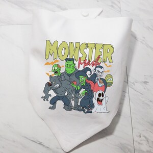 May include: White fabric tote bag with a colorful graphic of monsters. The text "Monster Mash" is printed in yellow and green letters.