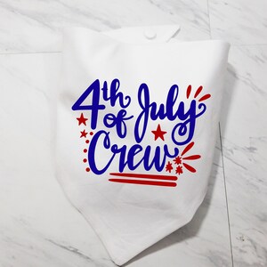 May include: White fabric bandana with the text "4th of July Crew" in blue and red lettering. The text is in a handwritten style with red stars and fireworks.