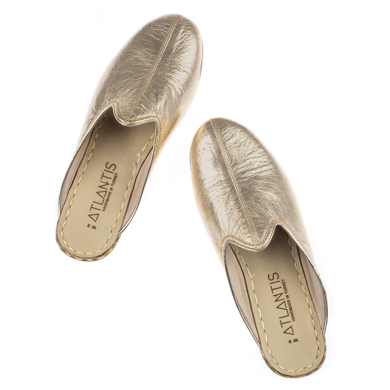 gold and white slippers