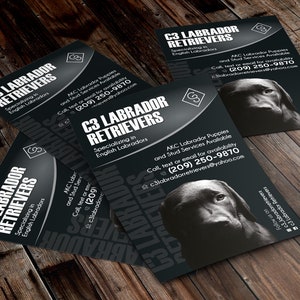 May include: A black and white business card with the text "C3 Labrador Retrievers" and "Specializing in English Labradors". The card also includes contact information, including a phone number and email address. A black Labrador Retriever puppy is pictured on the card.