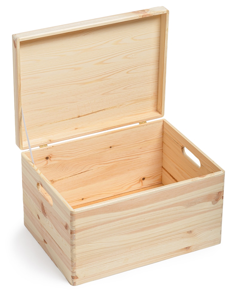 May include: An open, unfinished wooden storage box with a hinged lid. The box is rectangular with cut-out handles on the sides. The wood grain is visible, and the box is made of light-colored wood.
