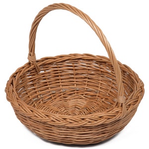 May include: A woven wicker basket with a single handle. The basket is light brown and has a round shape.
