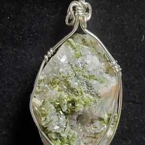 B3. Wayne Knight Pendant  that is from Mitchell County and has 5 elements.  Epidote,Calcite, Mica Quartz Moonstone and Albite Pyrite.