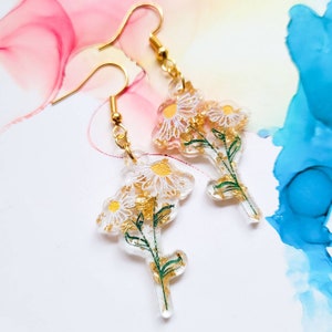 Handmade daisy flower resin earrings with encased golden leaf, gold plated hooks