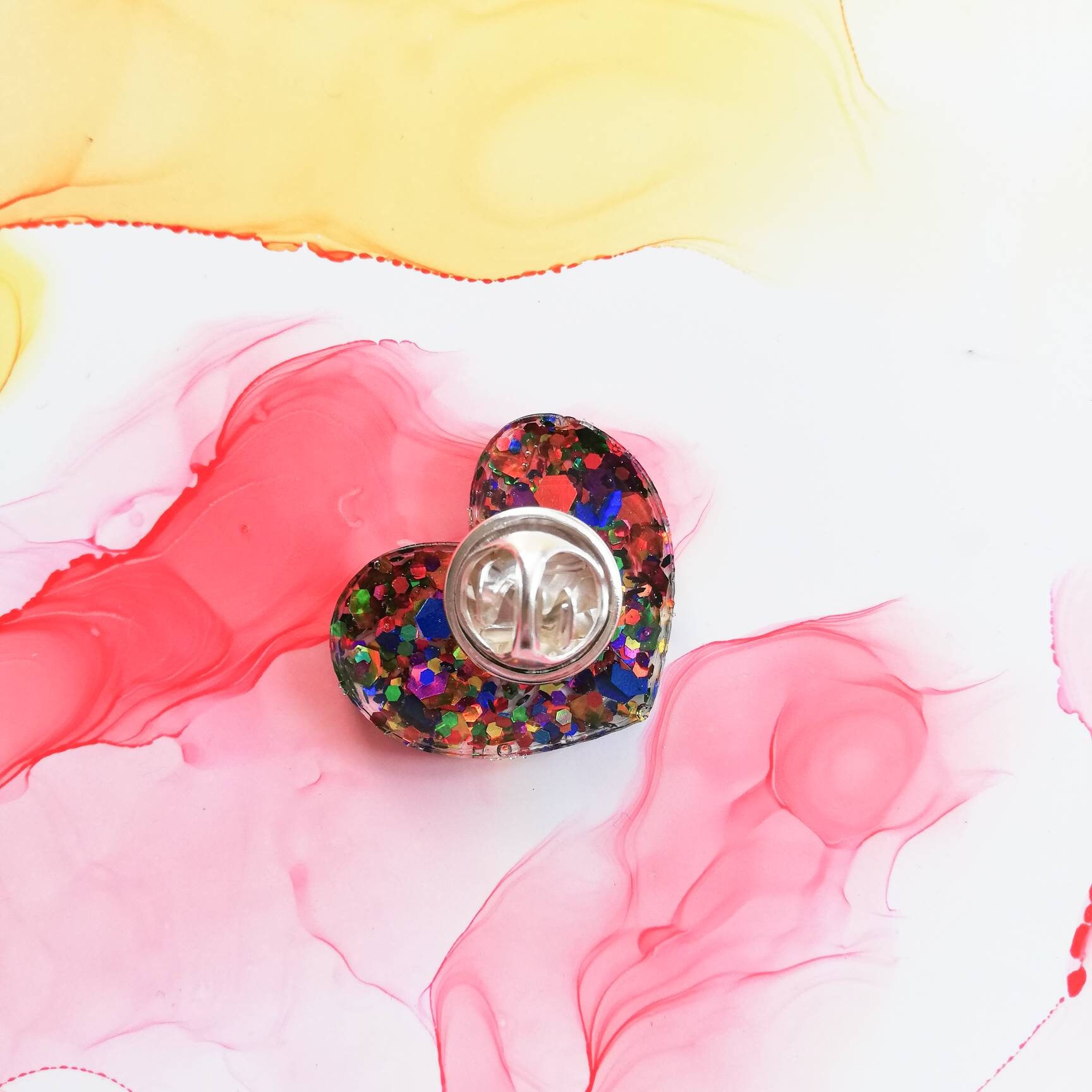 Handmade small rainbow glitter resin pocket hug pins on a | Etsy