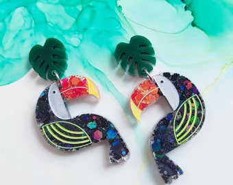 Handmade glitter resin toucan and monstera leaf earrings, summer earrings