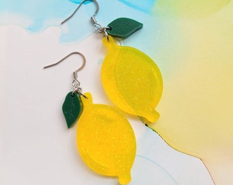 Handmade yellow and glitter transparent lemon resin earrings with green leaves