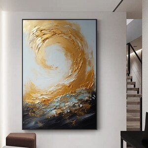 May include: Abstract painting with a swirling gold and white design on a black background. The painting has a textured, brushstroke effect.