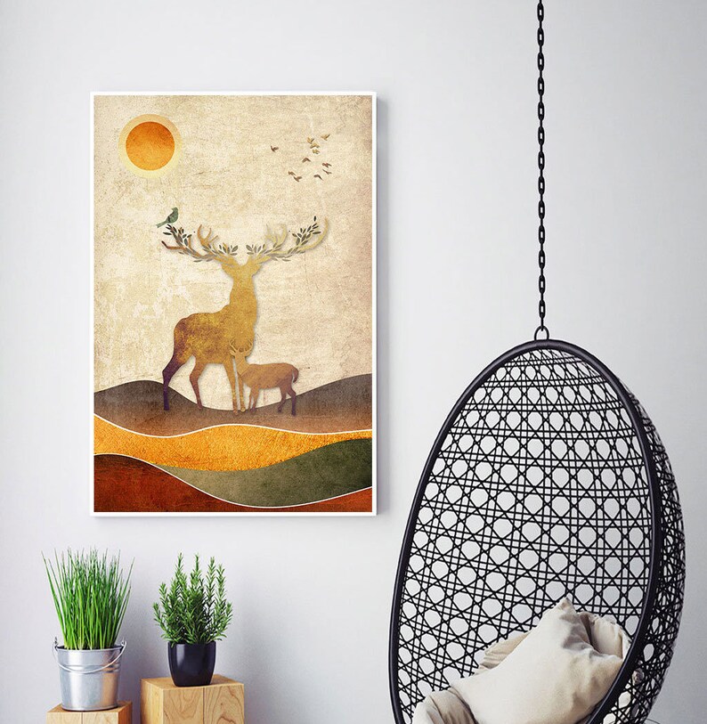 May include: A digital art print featuring a stylized deer with antlers and a fawn in a landscape setting. The background is a muted brown with orange and green accents. The sun is depicted as a yellow circle in the upper left corner.