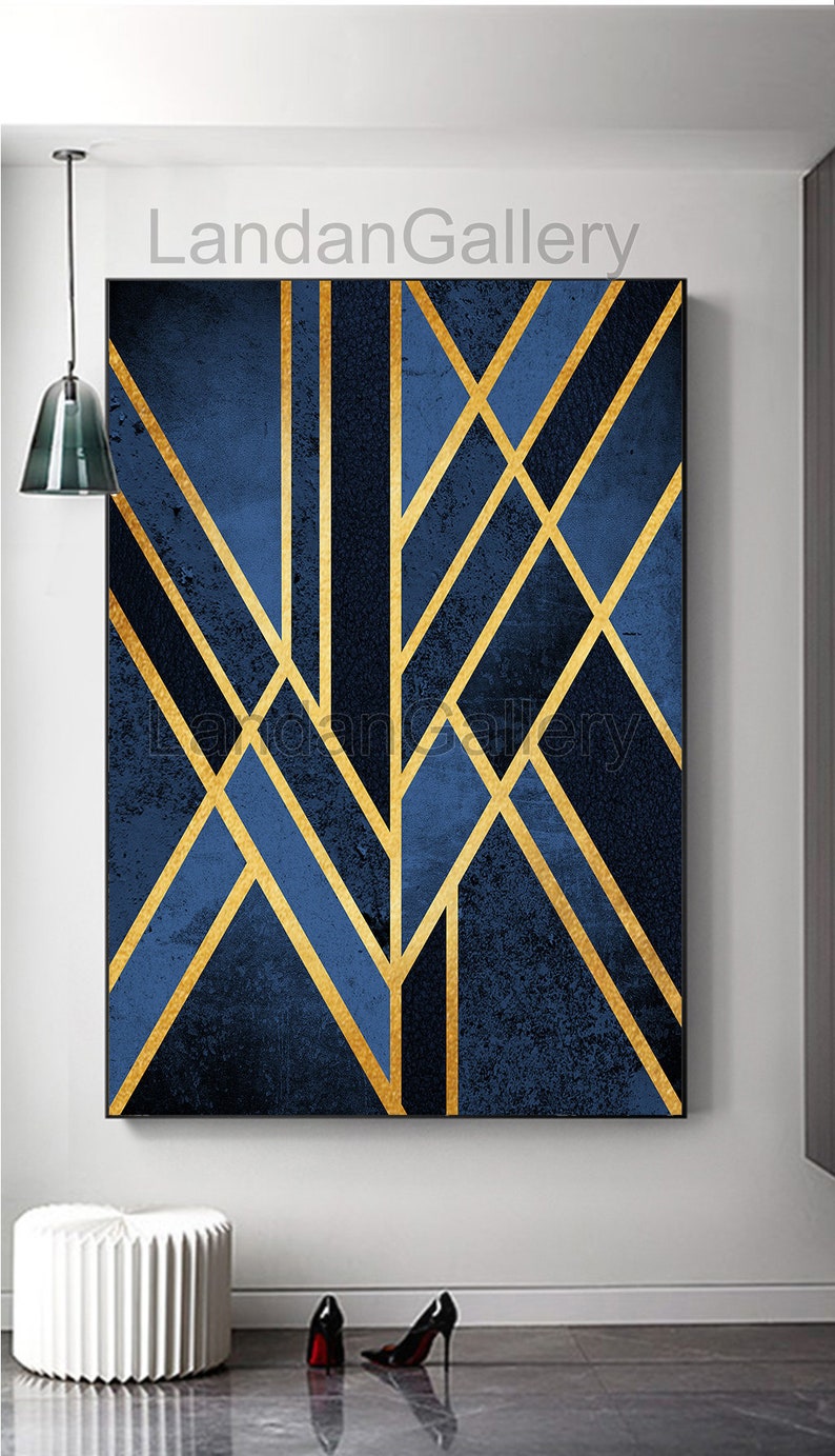 May include: Abstract geometric art print with a blue background and gold lines. The print features a modern design with a textured look.