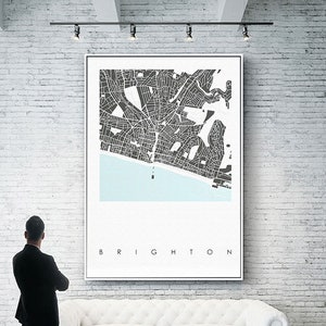 May include: A black and white city map print with the word "BRIGHTON" at the bottom. The map shows the streets and coastline of Brighton, England.