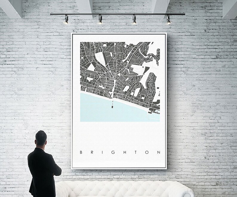 May include: A black and white city map print with the word "BRIGHTON" at the bottom. The map shows the streets and coastline of Brighton, England.