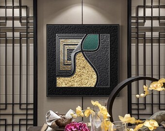May include: A modern abstract wall art piece with a black textured background, featuring gold and green geometric shapes. The artwork is framed in black and hangs above a dining table set with flowers and glassware.