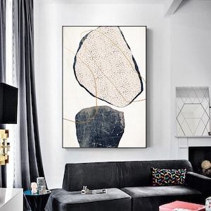 May include: Abstract art print featuring two irregular shapes, one in a light pink with white dots and the other in a dark blue with a textured look. Both shapes are outlined in gold and set against a white background.