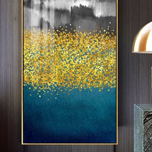 May include: Abstract art print with a gold glitter design on a blue and gray background. The print is framed in a gold frame.