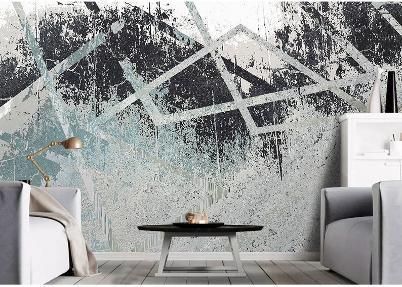 May include: Abstract geometric wall art with a distressed, textured background in shades of grey and blue. The design features white lines and shapes creating a modern and edgy look.