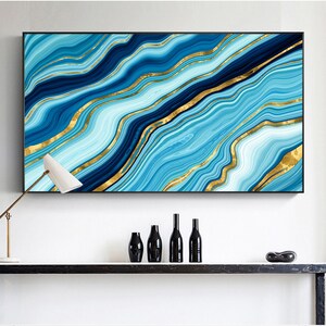 May include: Abstract wall art print featuring a blue and gold marble design. The print has a modern and contemporary style.