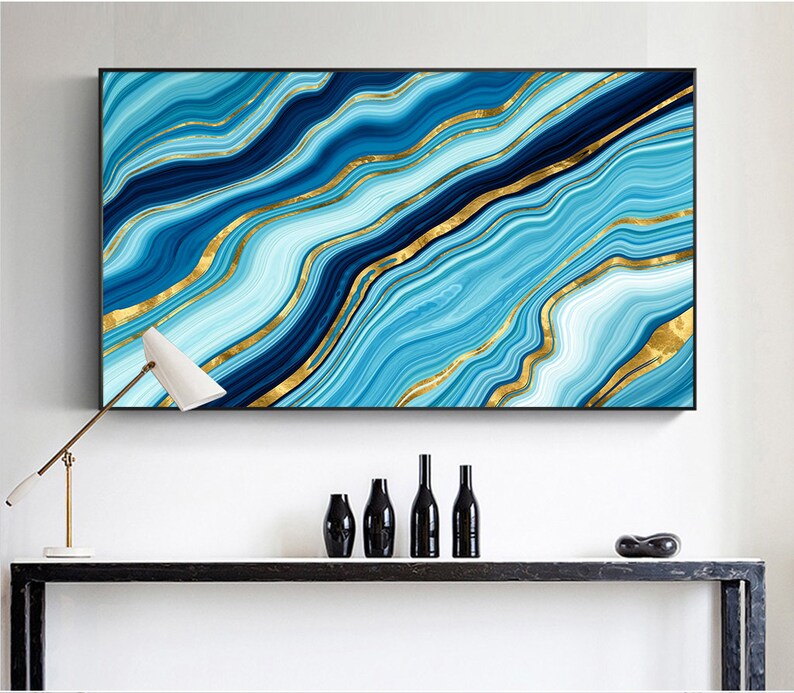 May include: Abstract wall art print featuring a blue and gold marble design. The print has a modern and contemporary style.