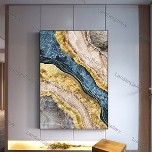 May include: Abstract art print featuring a blue, gold, and white color scheme. The print depicts a swirling, layered design with gold accents.
