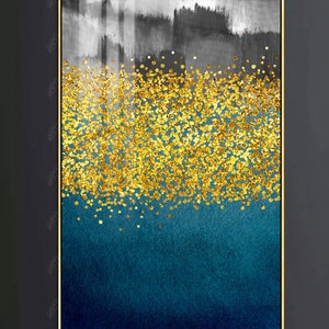 May include: Abstract art print with a gold glitter design on a blue and gray background. The print is framed in a gold frame.
