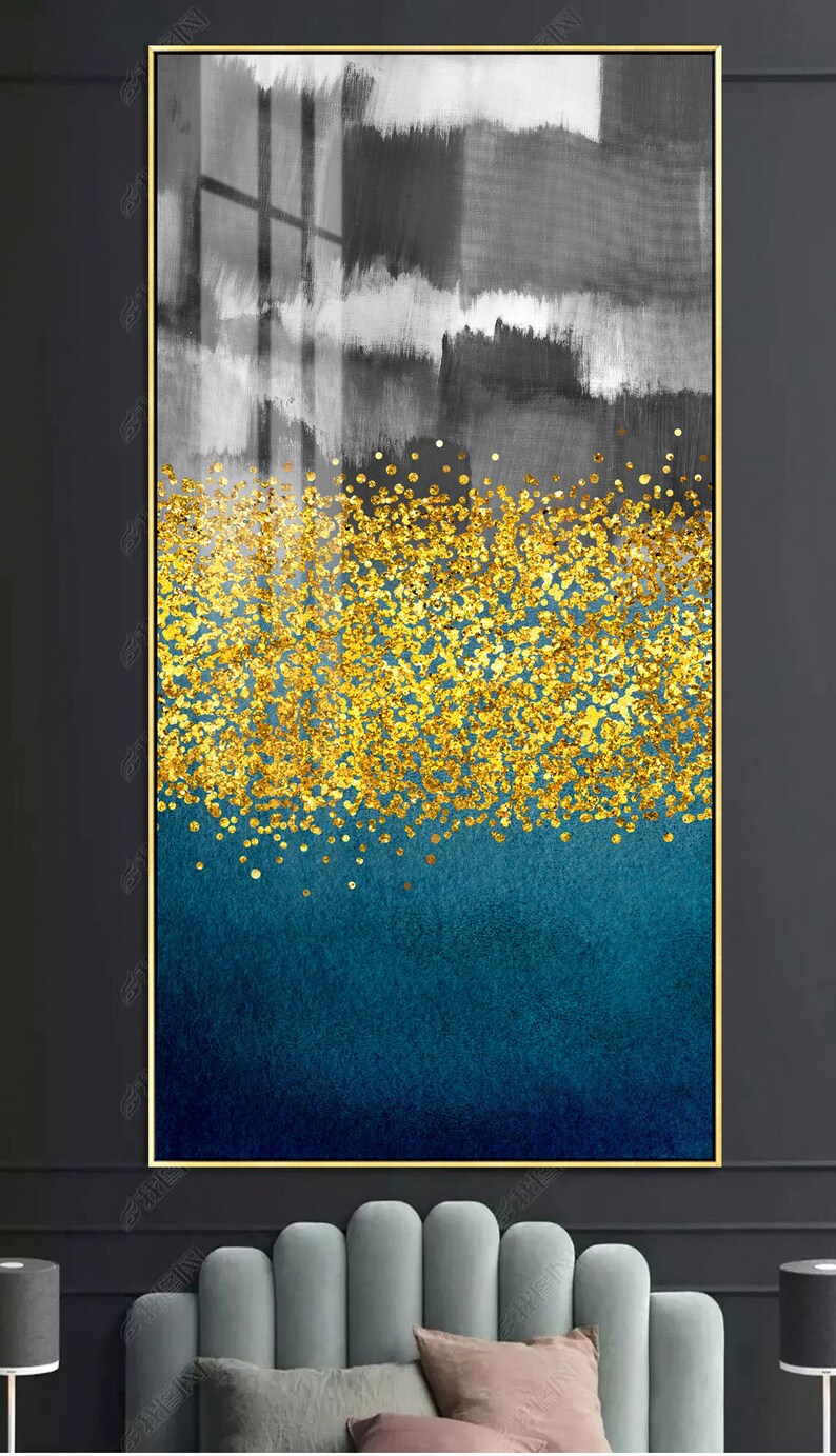 May include: Abstract art print with a gold glitter design on a blue and gray background. The print is framed in a gold frame.