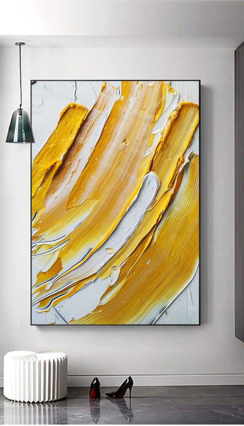 May include: Abstract painting with thick strokes of yellow and white paint on a canvas. The painting has a modern and contemporary style.