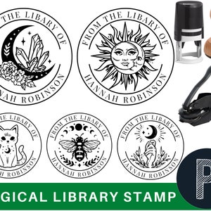 May include: A set of five black and white round rubber stamps with different magical designs. The stamps are for a library and feature the text "From the Library of Hannah Robinson". The stamps are shown with a black self-inking stamper.