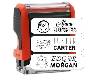 May include: Red self-inking stamp with three labels. The top label has a baby icon and the text "Alana HUGHES". The middle label has an airplane icon and the text "JUSTIN CARTER". The bottom label has a dinosaur icon and the text "EDGAR MORGAN".