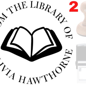 May include: A round, black and white self-inking stamp with the text "From the Library of Olivia Hawthorne" and a book icon in the center.