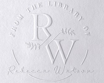 May include: White embossed stamp with the text "From the Library of" and the initials "R&W" with a leafy design. The text "Rebecca Watson" is below the stamp.