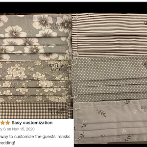 May include: A set of six gray fabric face masks with different patterns, including floral, polka dot, striped, and leaf designs. Each mask has the text "CHRISTY & JOHN XX.MMXX" printed on it.