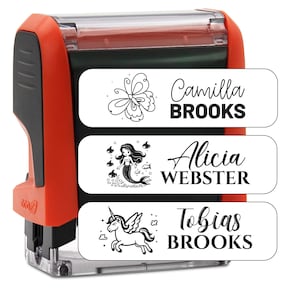 May include: Red self-inking stamp with three interchangeable stamp pads. The stamp pads feature a butterfly, a mermaid, and a unicorn with the names "Camilla BROOKS", "Alicia WEBSTER", and "Tobias BROOKS".