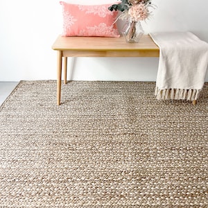 Braided jute hand woven with white touches ideal for farmhouse decor, nordic decor, vegan decor. A rug for bedroom, living aesthetic